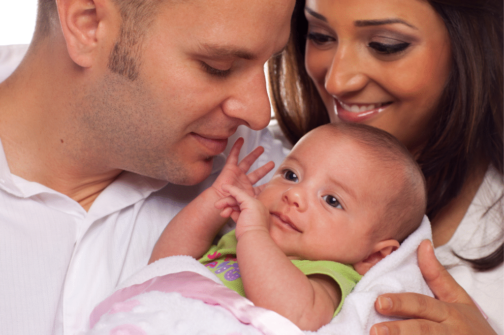 Smiling parents holding baby